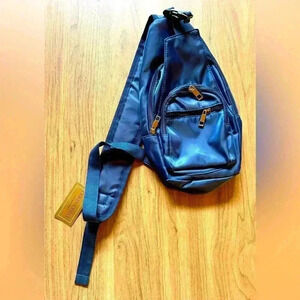 Gold Coast navy sling bag w several zip pockets, travel